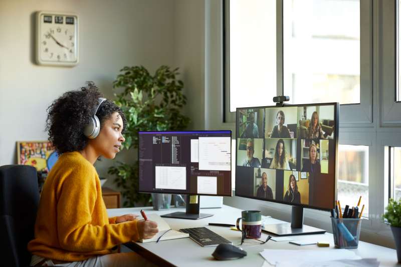Woman working remotely at a desk on a meeting